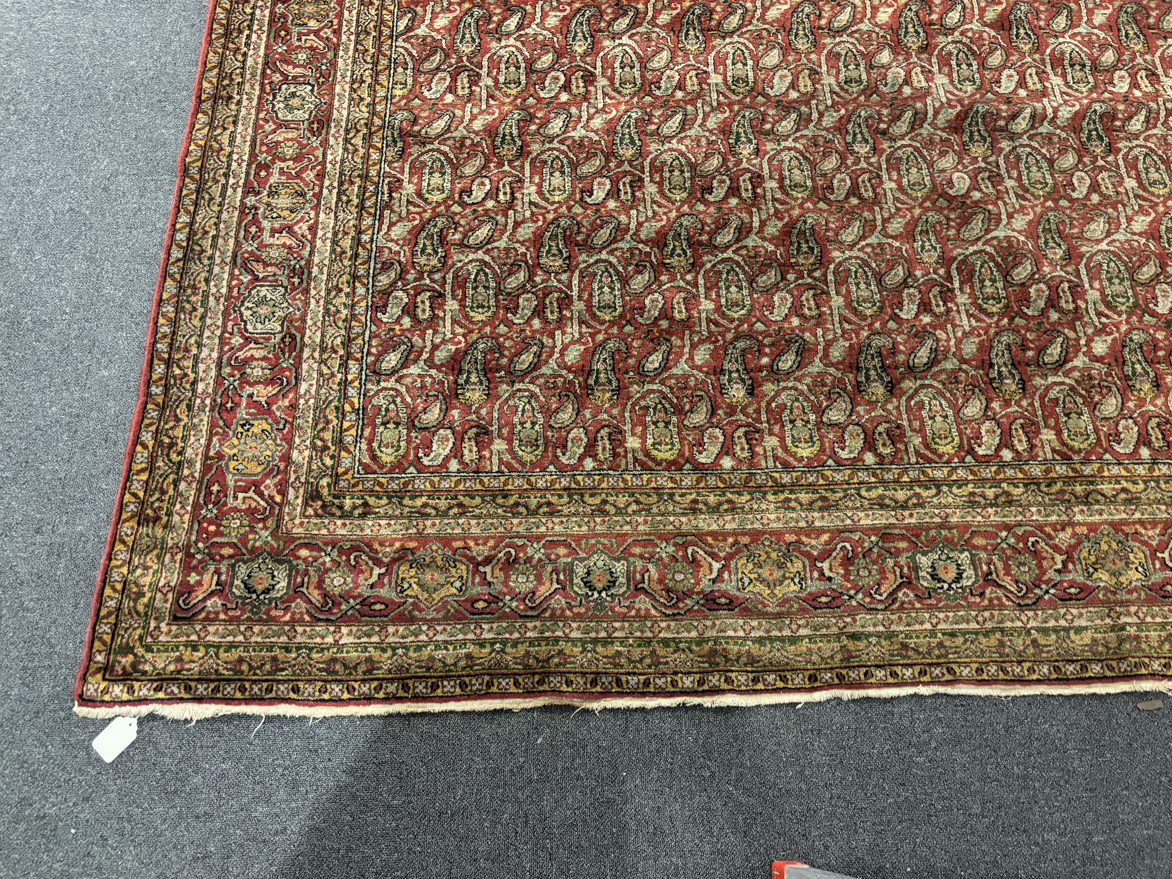 A Khorasan red ground carpet, approximately 12ft. X 9ft. (damage to one small area neatly repaired)